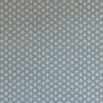 Detail of wallpaper in a minimalist quatrefoil pattern in gray on a blue field.