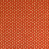 Detail of wallpaper in a minimalist quatrefoil pattern in yellow on a red field.