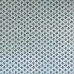 Detail of wallpaper in a minimalist quatrefoil pattern in navy on a light blue field.