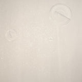 Detail of a wallpaper in a paint splatter print in metallic cream on a cream field.