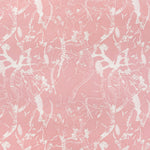 Detail of fabric in a branch and blossom print in cream and pink on a pink field.