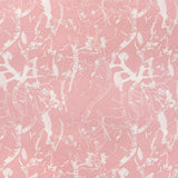 Detail of fabric in a branch and blossom print in cream and pink on a pink field.