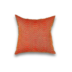 Square throw pillow with an undulating dimensional embroidery pattern in gold thread on a coral silk field.