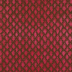 Detail of wallpaper in a repeating botanical grid print in red on a brown field.