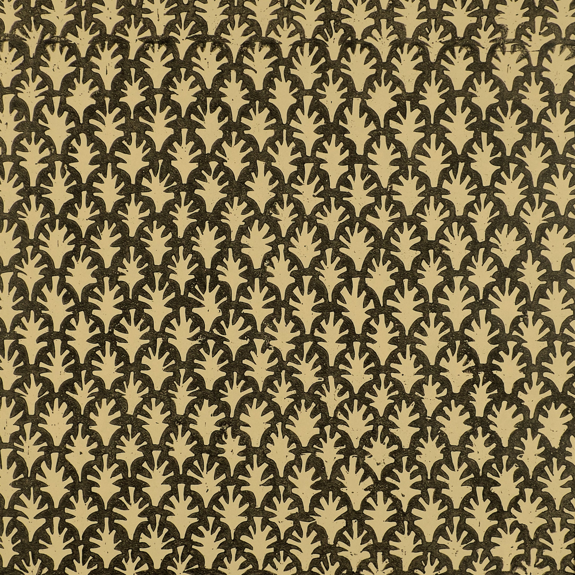 Detail of wallpaper in a repeating botanical grid print in yellow on a black field.