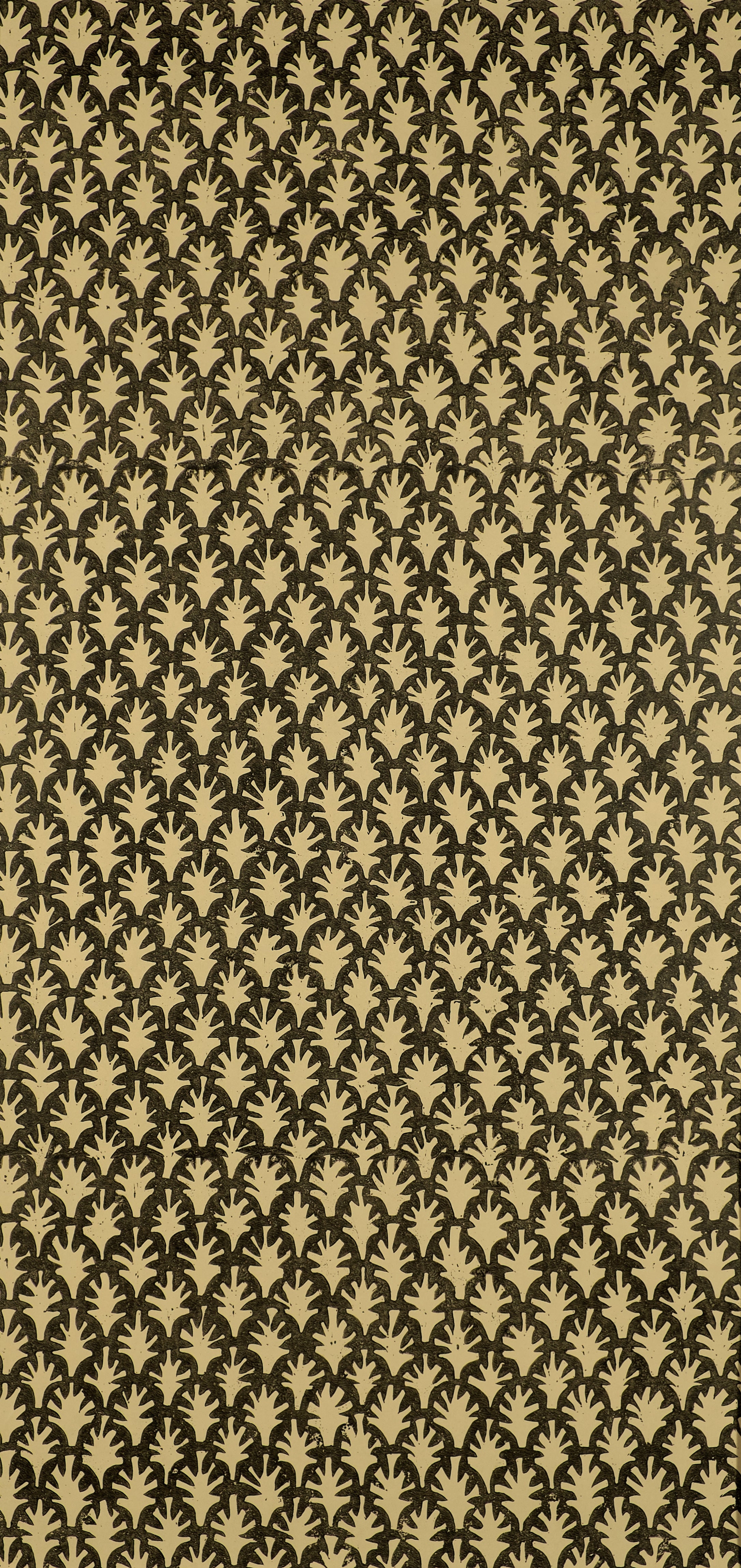 Detail of wallpaper in a repeating botanical grid print in yellow on a black field.