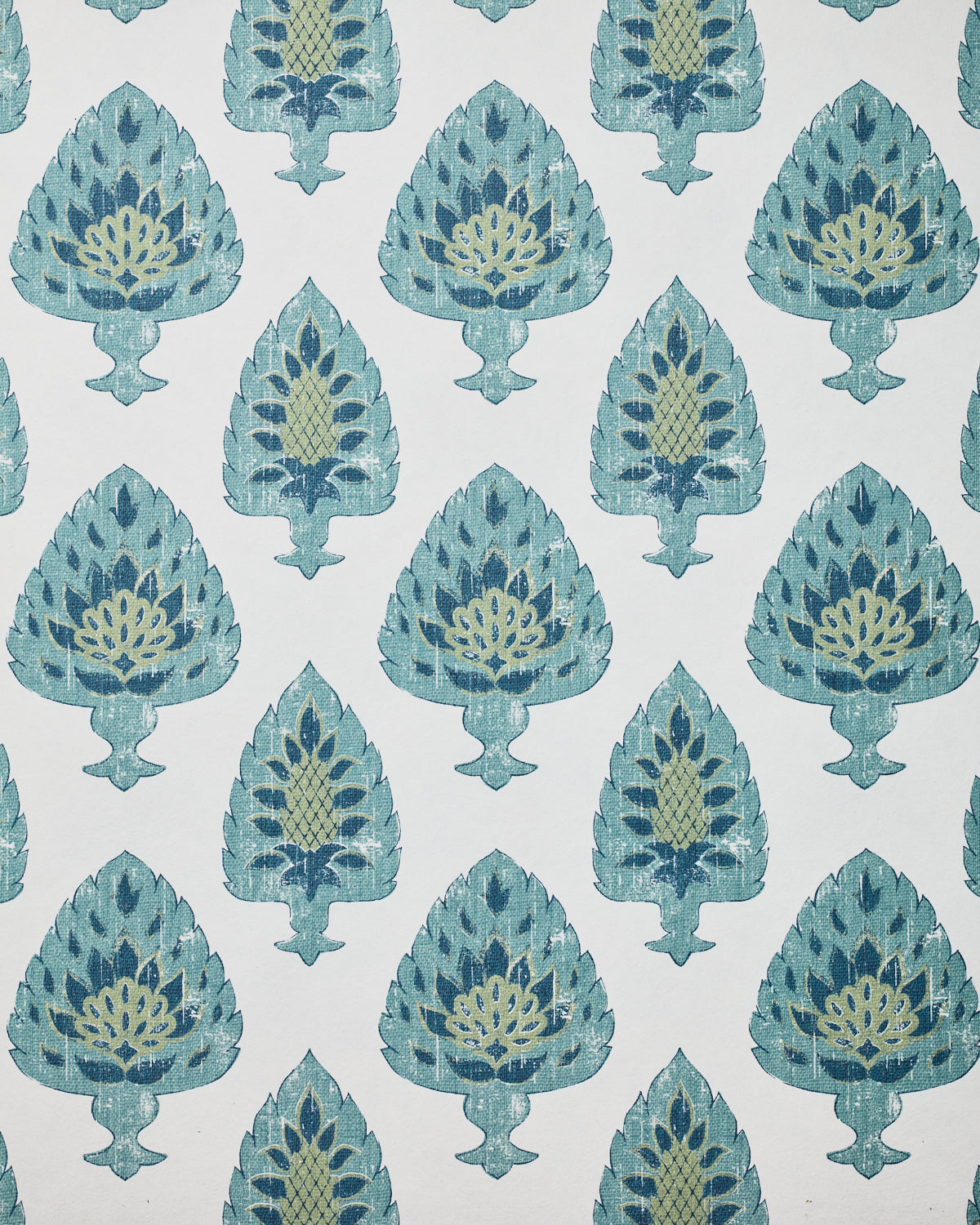 Detail of wallpaper in a botanical damask print in shades of blue, green and navy on a cream field.