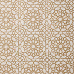 Detail of fabric in a small-scale lattice print in tan on a cream field.