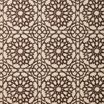 Detail of fabric in a small-scale lattice print in brown on a cream field.