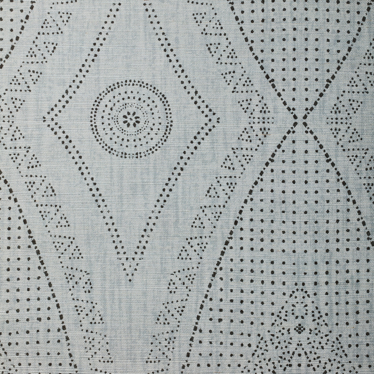 Detail of fabric in a dotted geometric print in gray on a light gray field.