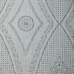 Detail of fabric in a dotted geometric print in gray on a light gray field.