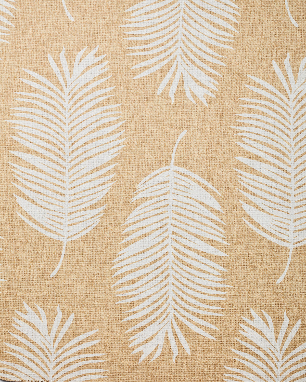 Detail of fabric in a large-scale leaf print in white on a tan field.