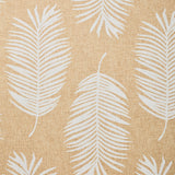 Detail of fabric in a large-scale leaf print in white on a tan field.