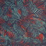 Detail of wallpaper in a dense leaf print in red and turquoise on a purple field.