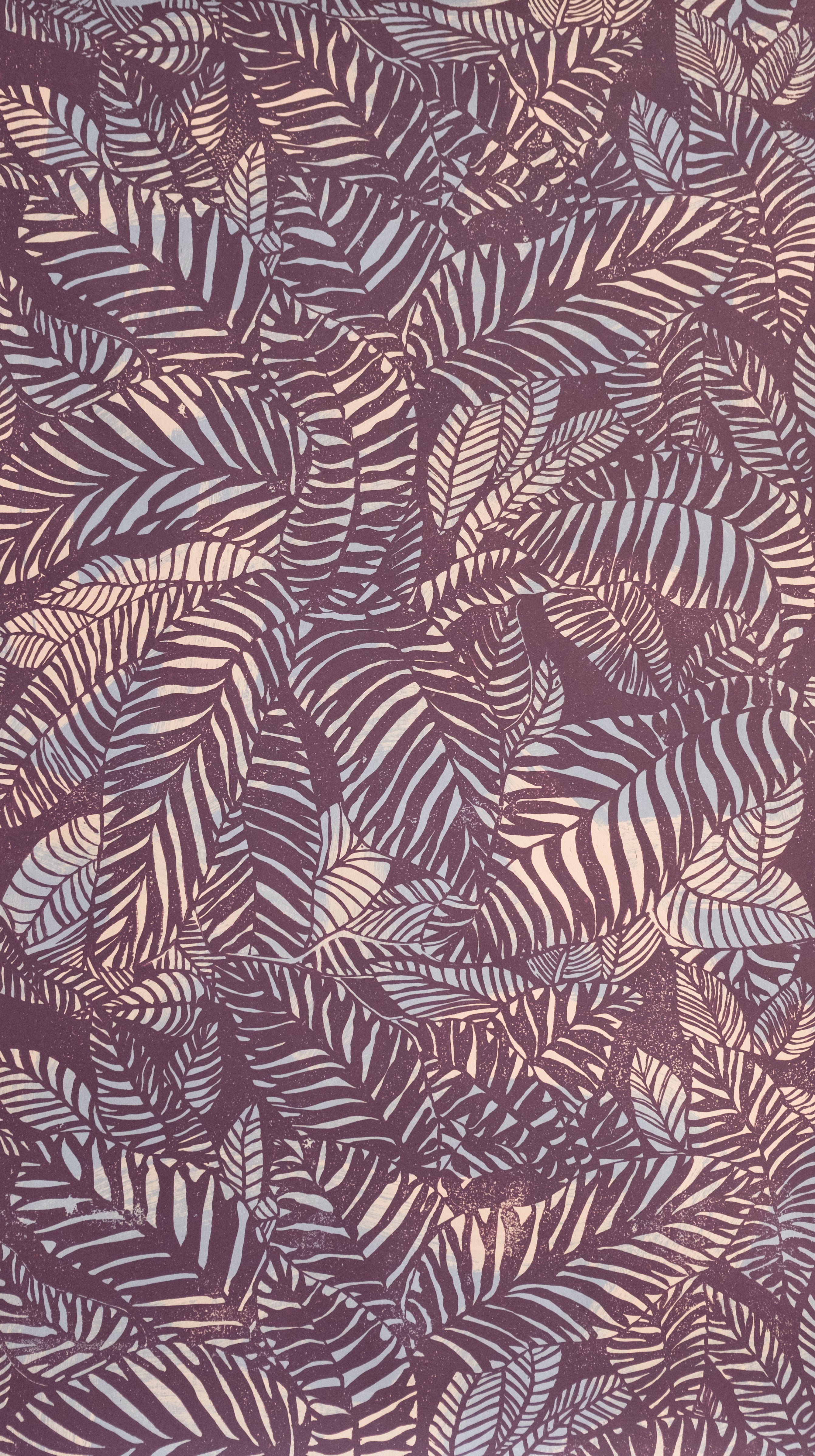 Detail of wallpaper in a dense leaf print in purple and tan on a maroon field.