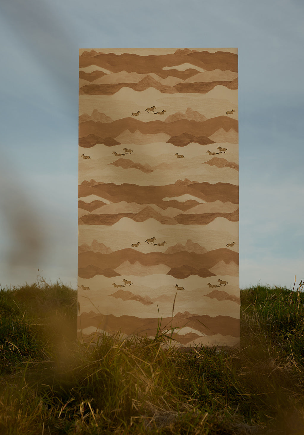 Fabric panel with mountain and horse pattern on grass and sky background