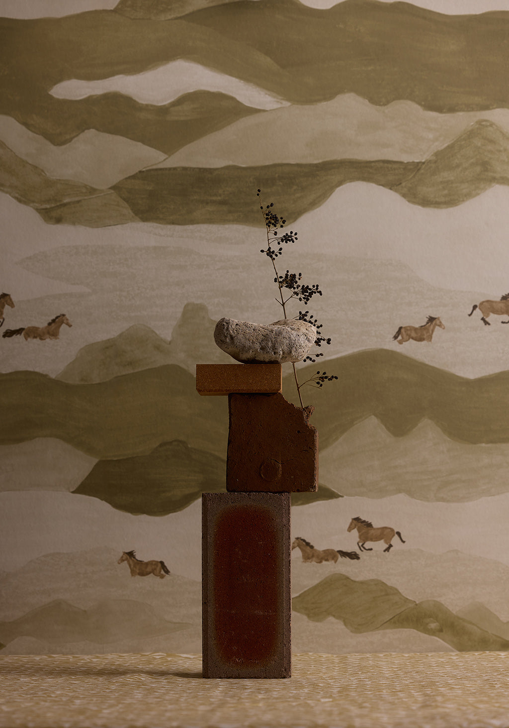 Decorative wall art with a mountain landscape and horses, featuring a central wooden sculpture.