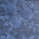 Detail of wallpaper in a minimalist floral print in blue on a mottled navy field.