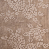 Detail of wallpaper in a minimalist floral print in cream on a mottled tan field.