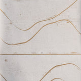 Detail of wallpaper in an abstract linear print in tan on a mottled cream field.