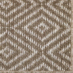Close-up of a textured ecru woven diamond pattern rug. 
