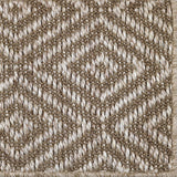 Close-up of a textured ecru woven diamond pattern rug. 