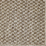Close-up of a textured sisal carpet in ecru.