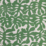 Detail of wallpaper in a playful repeating leaf print in green on a cream field.