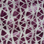 Detail of fabric in an abstract grid print in gray on a mottled purple field.