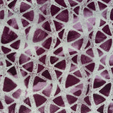 Detail of fabric in an abstract grid print in gray on a mottled purple field.