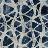 Detail of fabric in an abstract grid print in cream on a mottled navy field.