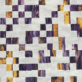 Detail of wallpaper in an abstract check print in mottled gold and purple on a cream field.