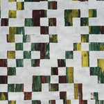 Detail of wallpaper in an abstract check print in mottled green, yellow and red on a white field.