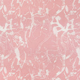 Detail of fabric in a branch and blossom print in cream and pink on a pink field.