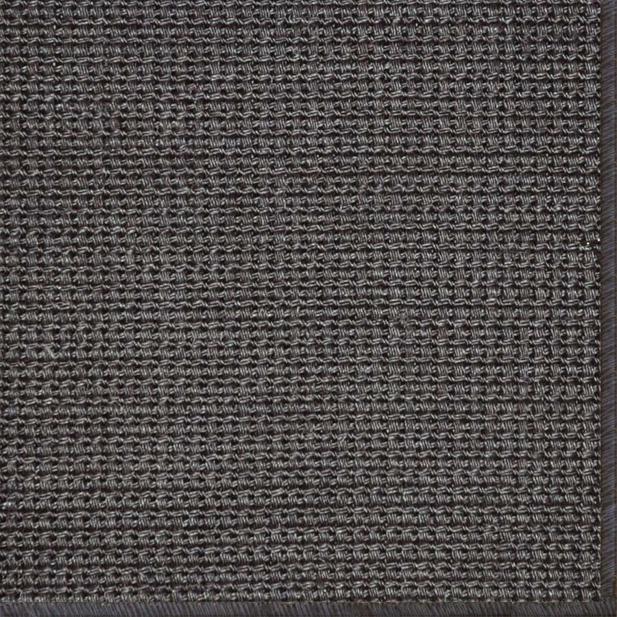Close-up of a textured woven performance carpet in dark brown.