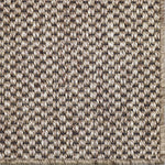 Close-up of a textured woven broadloom in natural with black warp.