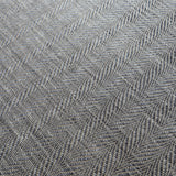 Detail of a woven leather rug in a striped wave texture in shades of gray with cream accents.