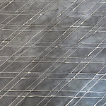 Close-up of a cowhide rug in gray with a white lattice overlay.