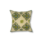 Square throw pillow with a floral diamond pattern in delicate Indian kantha embroidery on a gold field.