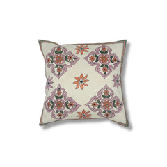 Square throw pillow with a floral diamond pattern in delicate Indian kantha embroidery on a white field.