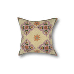 Square throw pillow with a floral diamond pattern in delicate Indian kantha embroidery on a tan field.