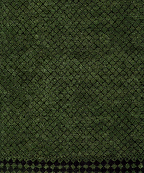 Handknotted rug in a black lattice design on a green field. 