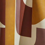 Draped wallpaper yardage in a curvilinear geometric grid print in shades of mustard, rust and purple on a cream field.