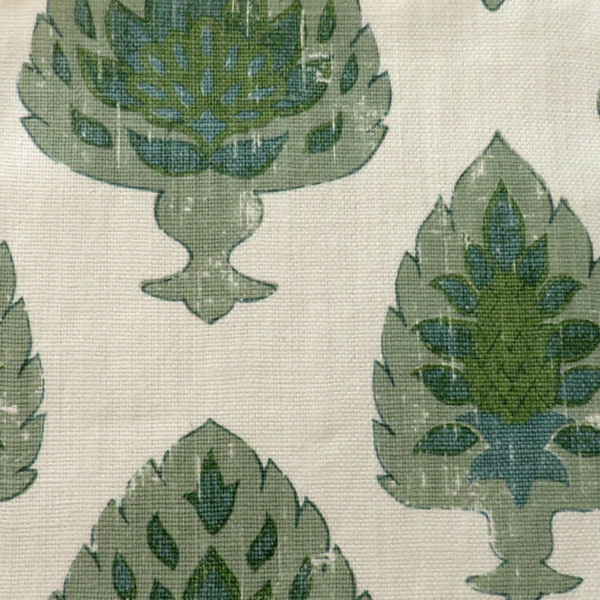 Detail of fabric in a botanical damask print in shades of green and blue on a cream field.