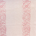 Detail of fabric in a painterly stripe print in shades of pink on a cream field.