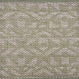 Handwoven rug sample in an angular geometric design in taupe on a sage green field. 