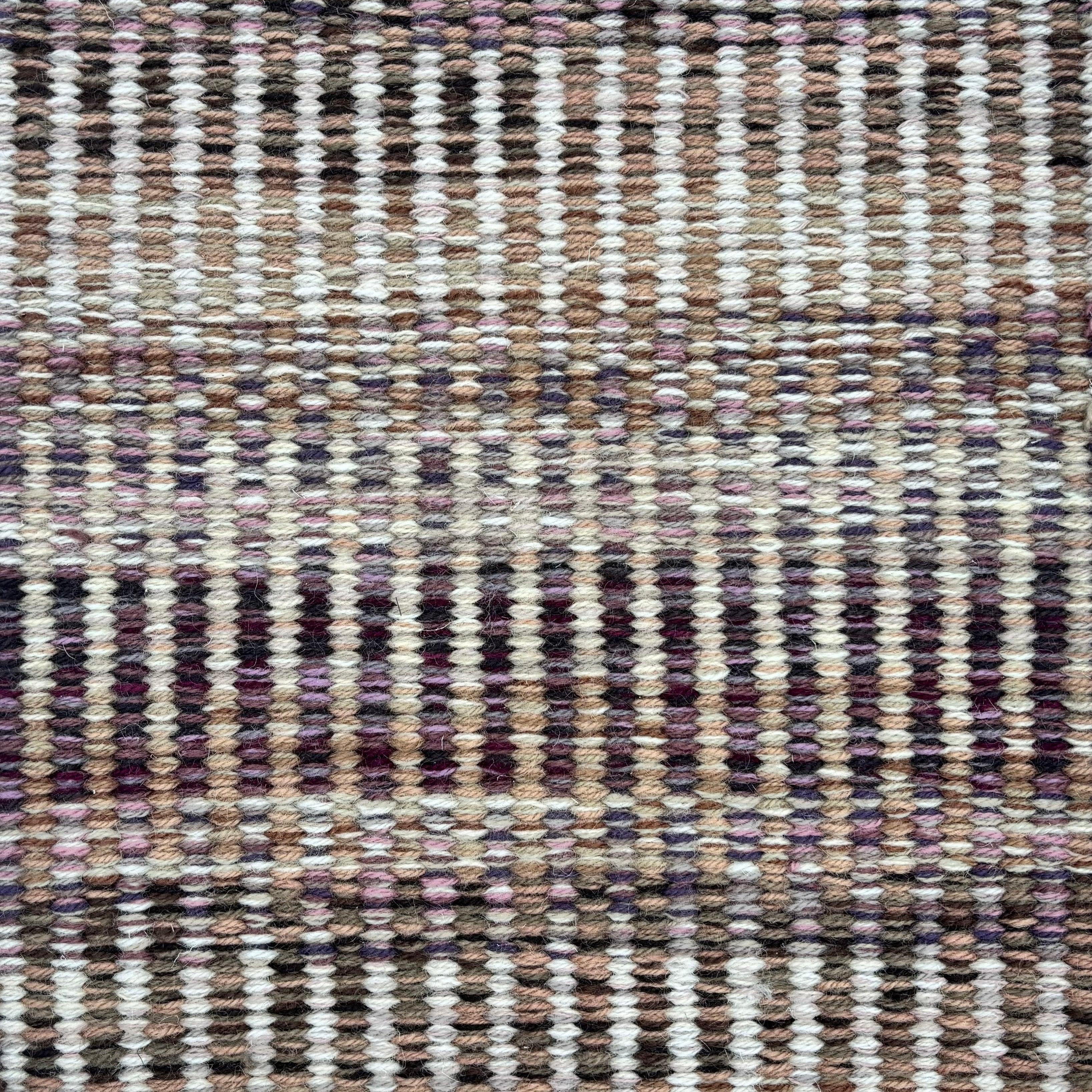 Handwoven rug sample in a textural stripe design in mottled shades of ivory, grey, plum purple and tan. 