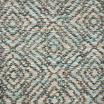 Handwoven rug sample in a radiating diamond pattern in shades of soft aqua, cream and green.