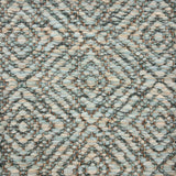 Handwoven rug sample in a radiating diamond pattern in shades of soft aqua, cream and green.