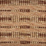 Handwoven rug sample in a abstract geometric pattern in tan and brown